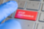 blue-finger-protective-glove-presses-red-button-keyboard-marked-topcareer